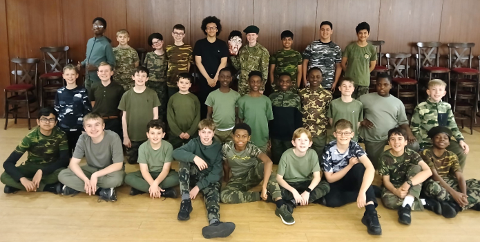 A group of boys in green uniforms posing for a photo

Description automatically generated