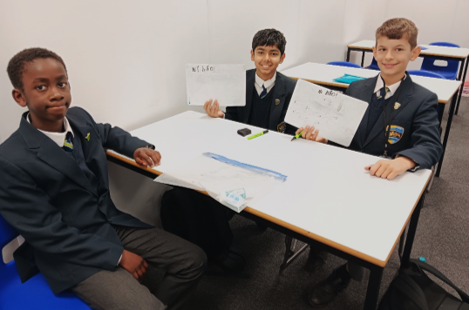 A group of boys sitting at a table

Description automatically generated