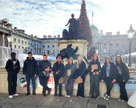 A group of people posing for a photo

Description automatically generated