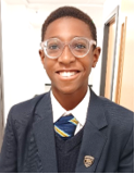 A child wearing glasses and a suit

Description automatically generated