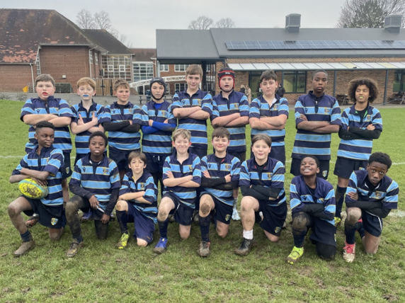 A group of boys in blue and white striped uniforms posing for a photo Description automatically generated