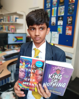 A child holding a book

AI-generated content may be incorrect.