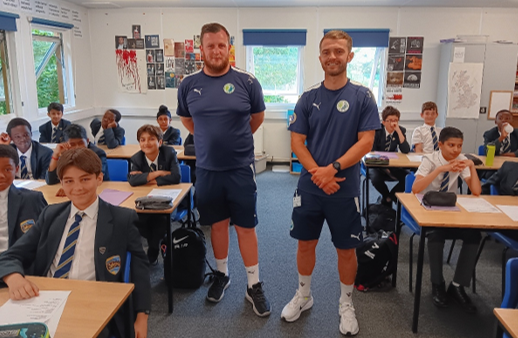 Two men standing in a classroom

AI-generated content may be incorrect.