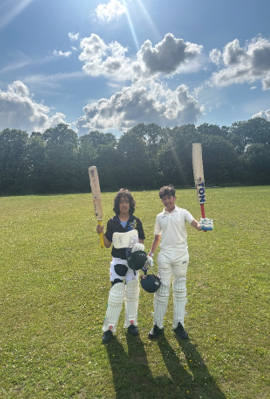 Two people holding baseball bats and helmets on a grass field

AI-generated content may be incorrect.