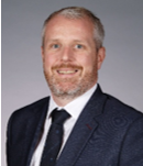 A person in a suit and tie

AI-generated content may be incorrect.