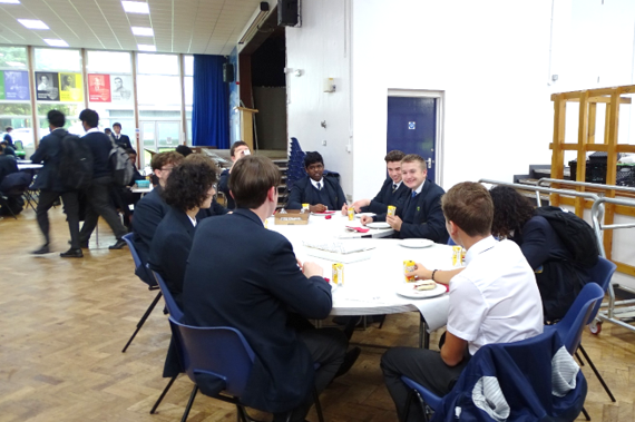 A group of people sitting around a table

AI-generated content may be incorrect.