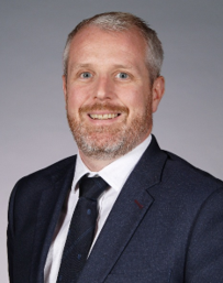 A person in a suit and tie

AI-generated content may be incorrect.