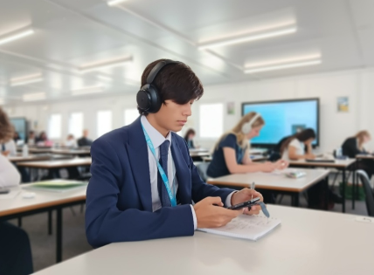 A person wearing headphones and using a phone

AI-generated content may be incorrect.