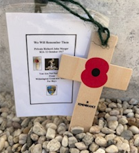 A cross with a red poppy on it

AI-generated content may be incorrect.