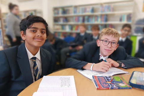 A group of boys sitting at a table in a library

AI-generated content may be incorrect.