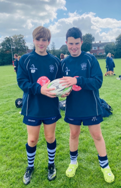 Two boys holding football balls

AI-generated content may be incorrect.